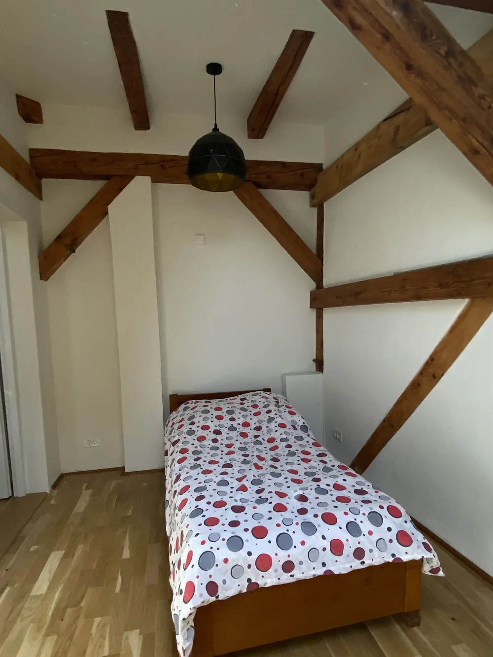 The bedroom of apartment 9, under the old beams