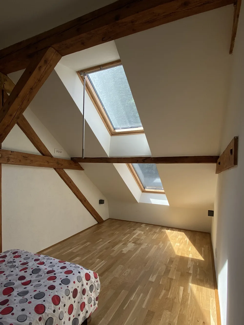 The bedroom of apartment 9, with the roof window above the bed