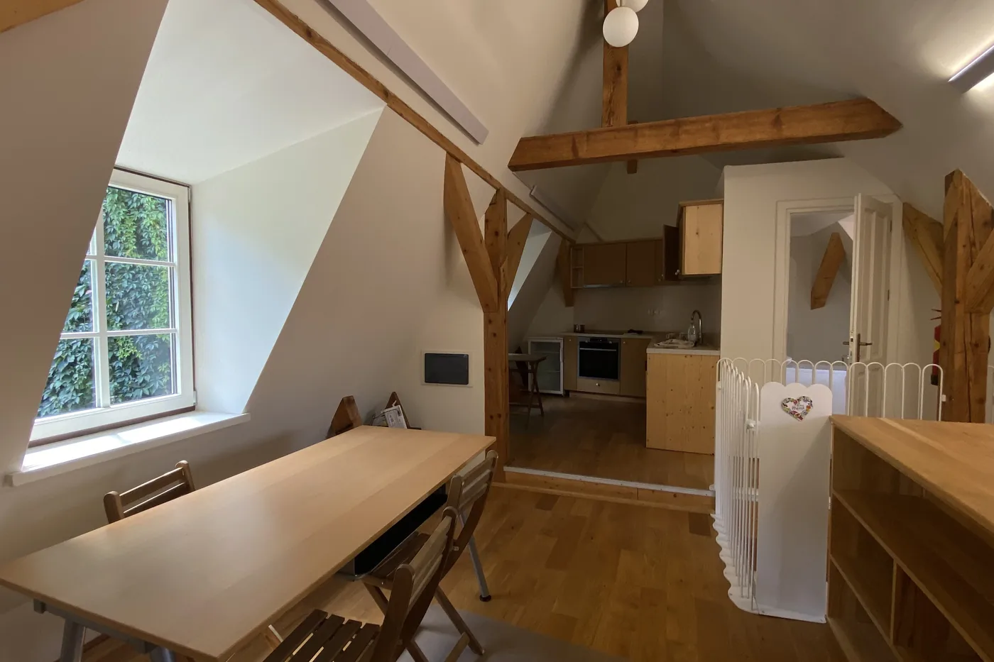 The dining table and fitted kitchen of apartment 9