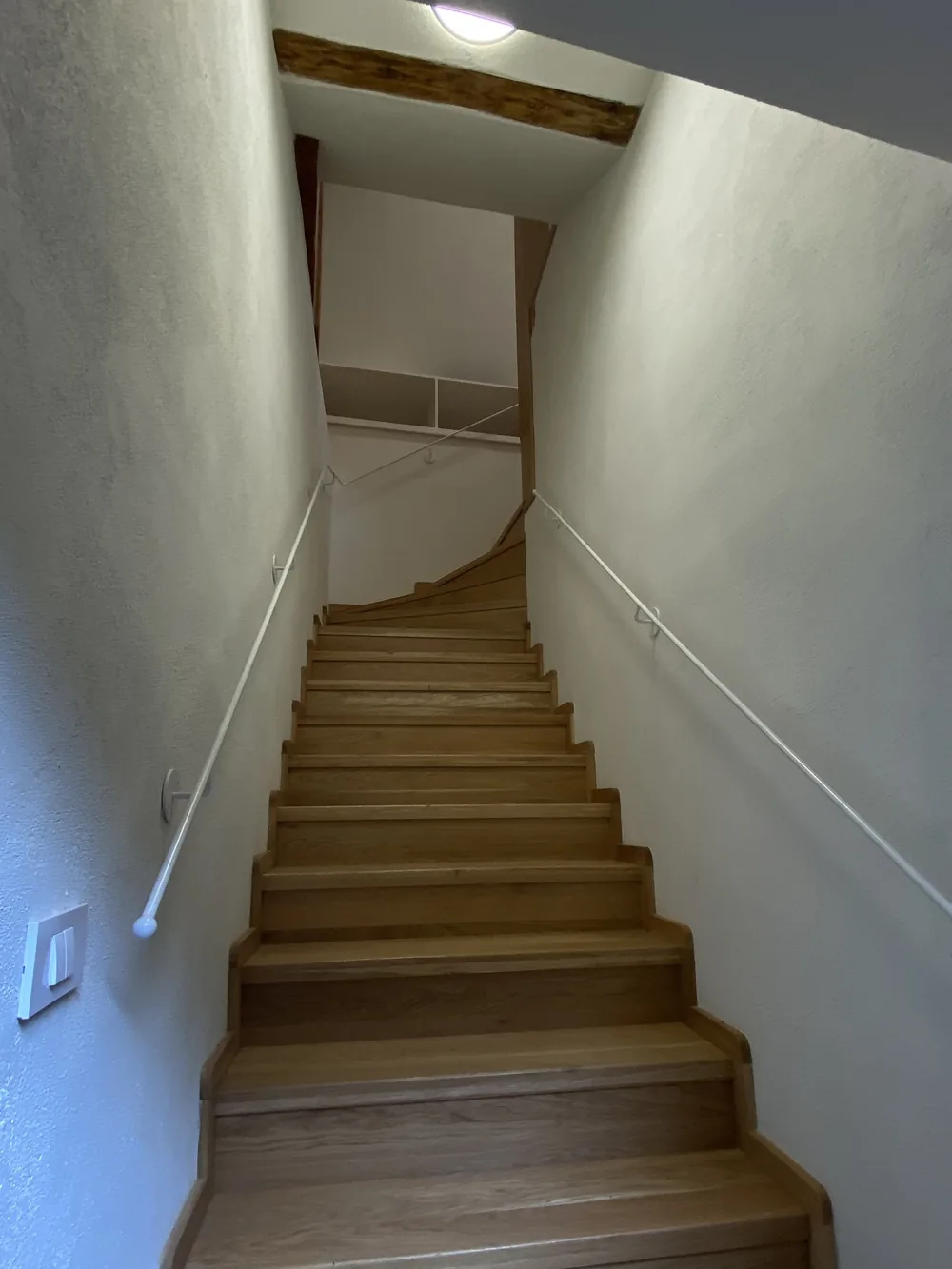 The private oak stair leading up into apartment 9